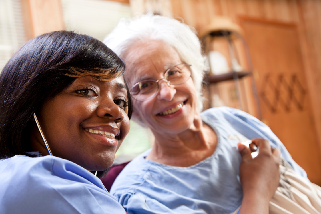 Healthcare: Home health nurse examines senior patient.